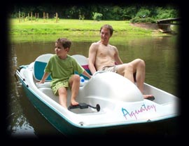 Noah and Justin boating on the pond.